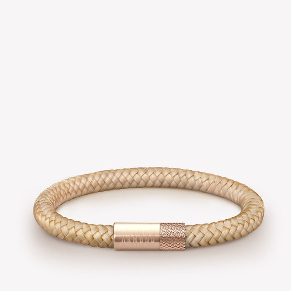 Beige dunne armband met rosé gouden stalen sluiting